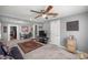 Open-concept living room with carpet, ceiling fan, and seamless flow to dining and kitchen at 1330 Ne 55Th St, Ocala, FL 34479