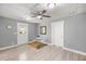 Bright living room with new vinyl floors, ceiling fan, and fresh paint throughout the home at 1330 Ne 55Th St, Ocala, FL 34479