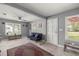 Comfortable living room with plush carpet, ceiling fan, and plenty of natural light from the windows at 1330 Ne 55Th St, Ocala, FL 34479