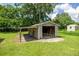 Exterior view of the wooden storage shed situated in the backyard at 1330 Ne 55Th St, Ocala, FL 34479