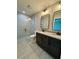 Modern bathroom with double vanity, granite countertops, and a glass-enclosed tile shower at 13305 Sw 114Th Pl, Dunnellon, FL 34432