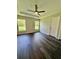 Comfortable bedroom featuring stylish floors, a ceiling fan, and natural light from the windows at 13305 Sw 114Th Pl, Dunnellon, FL 34432
