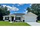 Beautiful single-story home with manicured lawn and attractive landscaping under a blue sky at 13305 Sw 114Th Pl, Dunnellon, FL 34432