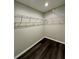 Spacious walk-in closet featuring dark wood floors and wire shelving for optimal storage and organization at 13305 Sw 114Th Pl, Dunnellon, FL 34432