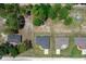 Birds-eye-view shows several homes with tree coverage, driveways, and green surroundings within a rural area at 13479 Sw 100Th Ln, Dunnellon, FL 34432