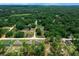 Expansive aerial view of multiple homes, tree coverage, and winding rural roads in a residential neighborhood at 13479 Sw 100Th Ln, Dunnellon, FL 34432