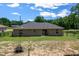 Exterior view of home's back featuring a patio and fenced yard offering privacy and relaxation at 13479 Sw 100Th Ln, Dunnellon, FL 34432
