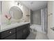 Bathroom featuring a granite countertop, shower over bath and decorative mirror at 13479 Sw 100Th Ln, Dunnellon, FL 34432