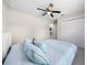 This carpeted bedroom offers a ceiling fan and closet for storage at 13479 Sw 100Th Ln, Dunnellon, FL 34432