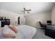 Comfortable bedroom with a ceiling fan, a desk workspace, and easy access to a walk-in closet at 13479 Sw 100Th Ln, Dunnellon, FL 34432