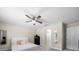 Tranquil bedroom featuring a ceiling fan, soft lighting, and convenient access to the en-suite bathroom at 13479 Sw 100Th Ln, Dunnellon, FL 34432