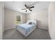 Cozy bedroom featuring a ceiling fan, window and carpeted floors at 13479 Sw 100Th Ln, Dunnellon, FL 34432
