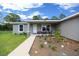 Charming single-story home featuring a well-maintained front yard and inviting front porch area at 13479 Sw 100Th Ln, Dunnellon, FL 34432
