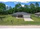 Charming single-story home featuring a well-maintained front yard and a convenient two-car garage at 13479 Sw 100Th Ln, Dunnellon, FL 34432