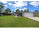 Charming single Gathering home featuring a well-manicured lawn, attached two-car garage, and welcoming front porch at 13479 Sw 100Th Ln, Dunnellon, FL 34432