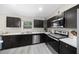 Modern kitchen featuring dark wood cabinets, stainless steel appliances, and bright countertops at 13479 Sw 100Th Ln, Dunnellon, FL 34432