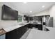 Modern kitchen featuring dark wood cabinets, stainless steel appliances, and bright countertops at 13479 Sw 100Th Ln, Dunnellon, FL 34432