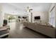 Open-concept living room seamlessly blends with a kitchen, complete with modern furniture and abundant natural light at 13479 Sw 100Th Ln, Dunnellon, FL 34432
