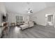 Bright living room with lots of natural light, gray wood floors and a large sectional sofa at 13479 Sw 100Th Ln, Dunnellon, FL 34432