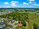 Aerial view of a neighborhood that backs to green space and blue sky at 13835 Se 85Th Cir, Summerfield, FL 34491