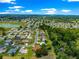 High angle aerial view of a neighborhood with lake and trees and blue sky at 13835 Se 85Th Cir, Summerfield, FL 34491