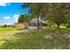Backyard view showing the covered and screened patios and mature trees at 13835 Se 85Th Cir, Summerfield, FL 34491