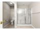 Compact bathroom featuring a toilet, tiled floor, and glass-enclosed shower at 13835 Se 85Th Cir, Summerfield, FL 34491