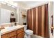Neutral bathroom featuring a single sink vanity and shower with striped curtain at 13835 Se 85Th Cir, Summerfield, FL 34491