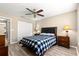 This bedroom features a ceiling fan, wood-look floors, and closet space at 13835 Se 85Th Cir, Summerfield, FL 34491