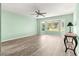 Bright bedroom featuring wood floors, ceiling fan, and bay window providing ample natural light at 13835 Se 85Th Cir, Summerfield, FL 34491