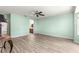 Spacious bedroom with a ceiling fan, an open doorway, and wood-look floors at 13835 Se 85Th Cir, Summerfield, FL 34491