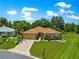 Charming one-story home with manicured lawn, mature trees, and well maintained landscape at 13835 Se 85Th Cir, Summerfield, FL 34491