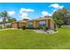 Attractive single-story home with a well-maintained lawn, landscaped shrubs, and symmetrical windows with a view at 13835 Se 85Th Cir, Summerfield, FL 34491