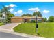 Charming single-story home with manicured lawn and a welcoming two-car garage at 13835 Se 85Th Cir, Summerfield, FL 34491