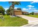 Beautiful well maintained lawn, mature landscaping, and two car garage at 13835 Se 85Th Cir, Summerfield, FL 34491
