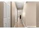 Hallway with modern floors leading to various rooms, highlighting the home's layout at 13835 Se 85Th Cir, Summerfield, FL 34491