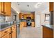 Well-lit kitchen featuring wood cabinets, stainless steel appliances, and tile flooring at 13835 Se 85Th Cir, Summerfield, FL 34491