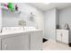 Clean laundry room with washer, dryer, and storage shelving at 13835 Se 85Th Cir, Summerfield, FL 34491