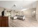 Expansive living room with vaulted ceiling, hardwood floors, recessed lights, and open floor plan at 13835 Se 85Th Cir, Summerfield, FL 34491