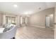 Light-filled living area featuring hardwood floors, large windows, and an open layout at 13835 Se 85Th Cir, Summerfield, FL 34491
