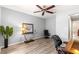 Office space featuring wood-look floors, a ceiling fan, and a glass-topped desk at 13835 Se 85Th Cir, Summerfield, FL 34491