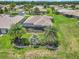 Gorgeous view of a home featuring a screened-in lanai, well-manicured lawn, and mature palm trees for privacy at 1443 Sw 161St St, Ocala, FL 34473