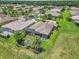 Expansive aerial view of a well-maintained single-Gathering home with a screened-in lanai and lush landscaping in a quiet community at 1443 Sw 161St St, Ocala, FL 34473