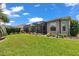 View of back of house from the yard showing the screened in patio at 1443 Sw 161St St, Ocala, FL 34473