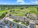 Overhead shot of the clubhouse surrounded by a golf course, palm trees and ample parking at 1443 Sw 161St St, Ocala, FL 34473