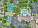 Aerial view of community amenities, including pool, tennis courts, and lush landscaping creating a resort-style living experience at 1443 Sw 161St St, Ocala, FL 34473
