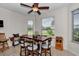 Bright dining area with a wooden table, seating for six, and large windows at 1443 Sw 161St St, Ocala, FL 34473