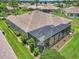 Exterior view of the home with a screened lanai, green lawn and landscaped borders at 1443 Sw 161St St, Ocala, FL 34473