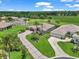 Inviting home exterior featuring a well-manicured lawn, decorative driveway, and tropical palm trees under a sunny sky at 1443 Sw 161St St, Ocala, FL 34473