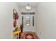 Bright foyer with a decorative front door, wooden floors, and a view into the living area at 1443 Sw 161St St, Ocala, FL 34473